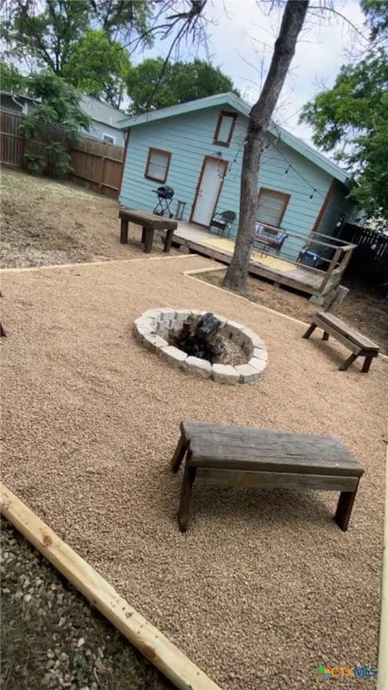 747 Oasis St, New Braunfels, TX 78130 - view of yard featuring fence, a fire pit, and a wooden deck