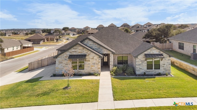 view of front of property featuring central AC unit and a front yard