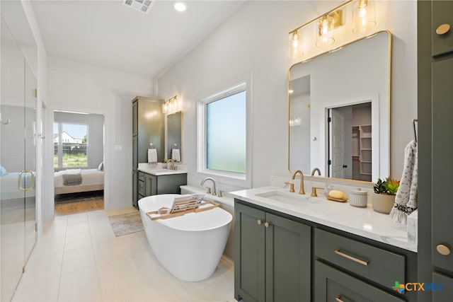 bathroom with tile patterned flooring, vanity, and shower with separate bathtub