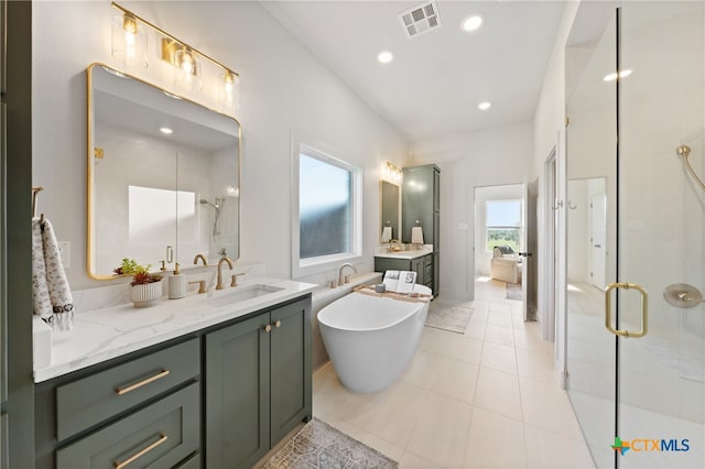 bathroom with vanity, tile patterned flooring, and plus walk in shower