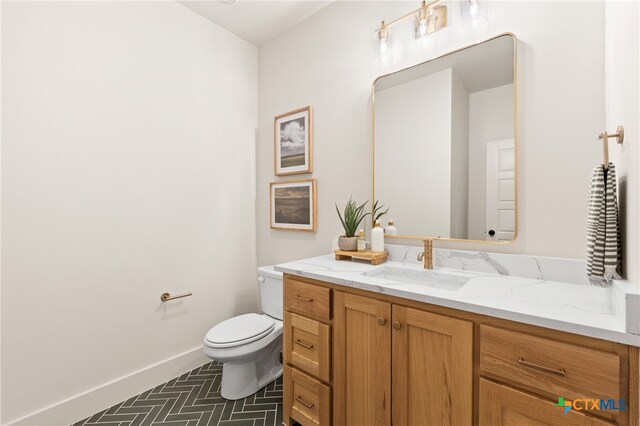 bathroom featuring tile patterned floors, vanity, and toilet