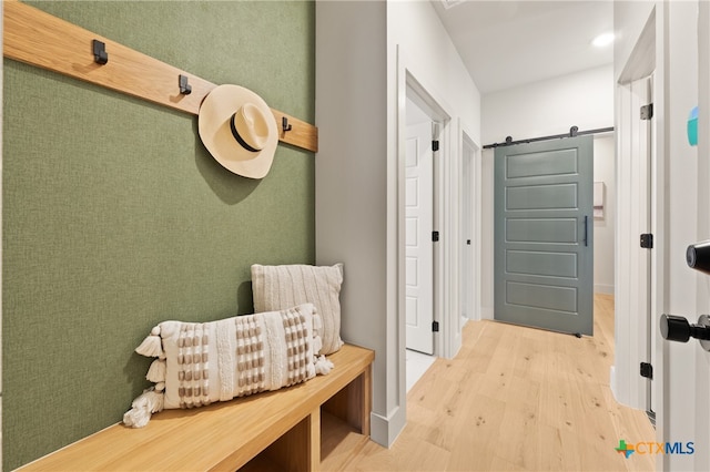 mudroom featuring hardwood / wood-style flooring and a barn door