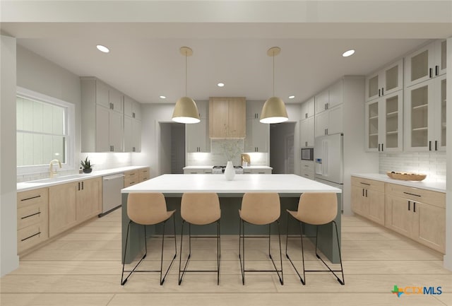 kitchen featuring white refrigerator, stainless steel dishwasher, a kitchen island with sink, and sink