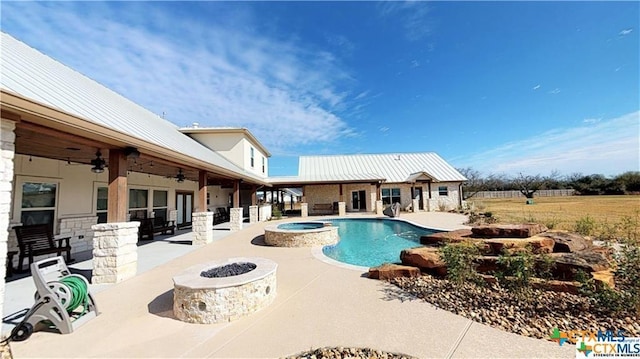 158 Sendera Loop, Victoria, TX 77904 - view of swimming pool featuring a ceiling fan, an outdoor fire pit, a patio area, and a pool with connected hot tub