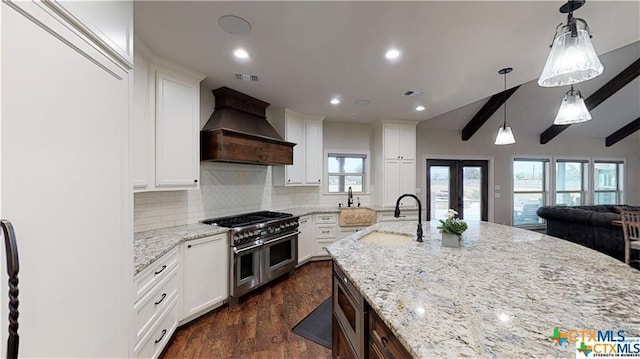 158 Sendera Loop, Victoria, TX 77904 - kitchen featuring custom exhaust hood, stainless steel appliances, a sink, backsplash, and french doors