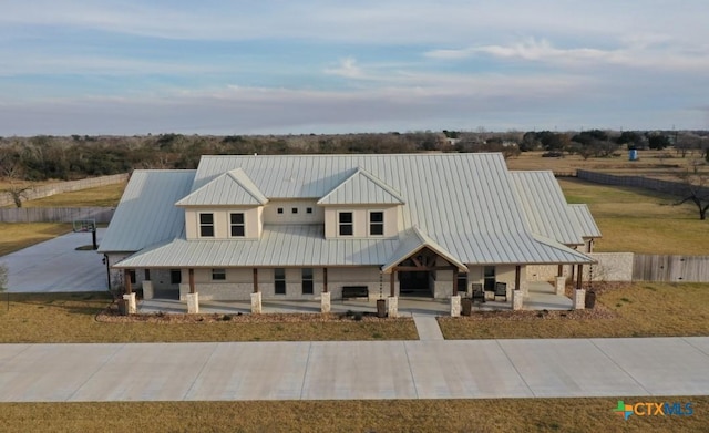 158 Sendera Loop, Victoria, TX 77904 - view of front of property with covered porch, stone siding, and metal roof