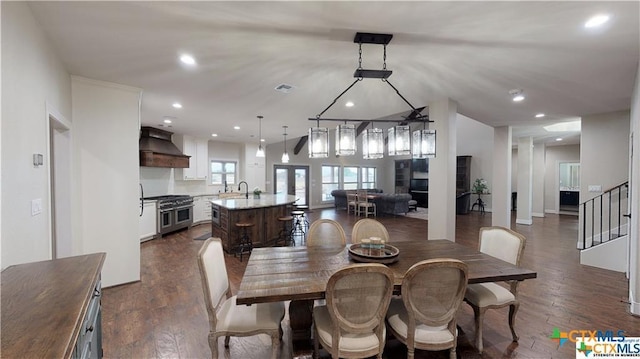 158 Sendera Loop, Victoria, TX 77904 - dining room with dark wood-style flooring, recessed lighting, and stairway