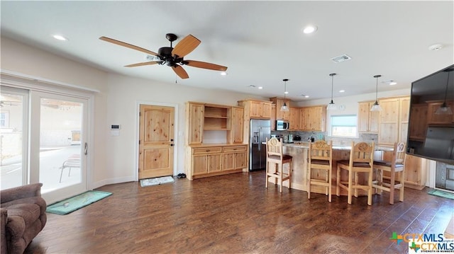 158 Sendera Loop, Victoria, TX 77904 - kitchen featuring appliances with stainless steel finishes, a ceiling fan, a kitchen breakfast bar, dark wood finished floors, and recessed lighting