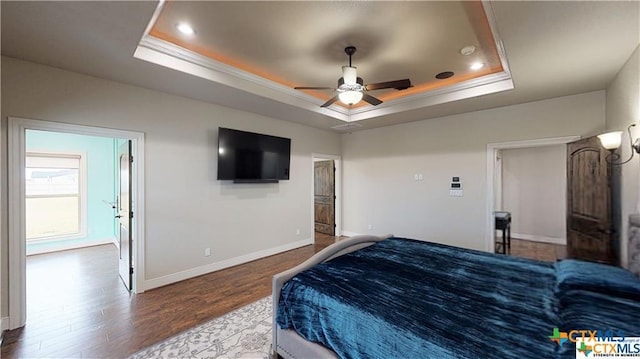 158 Sendera Loop, Victoria, TX 77904 - bedroom with a tray ceiling, baseboards, wood finished floors, ornamental molding, and recessed lighting
