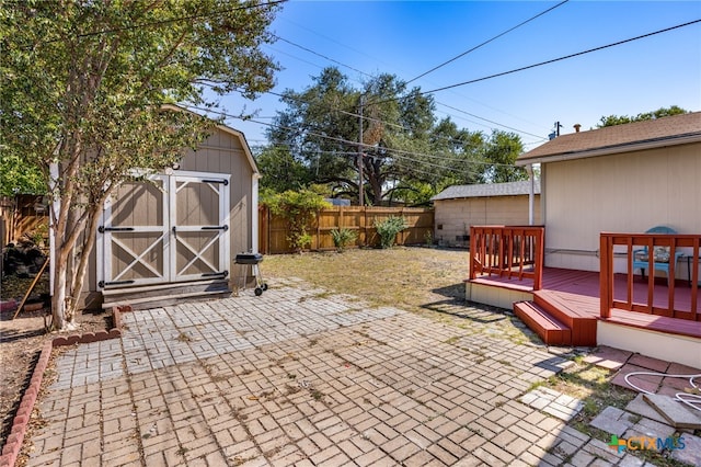 view of patio / terrace featuring a shed and a deck