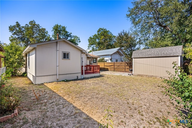 view of yard with a storage unit and a deck