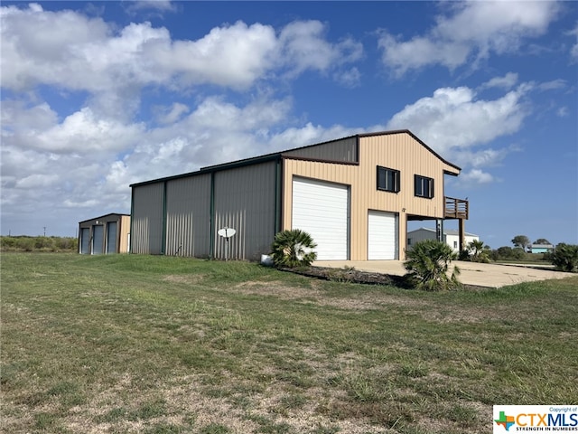 view of outbuilding featuring a garage and a yard