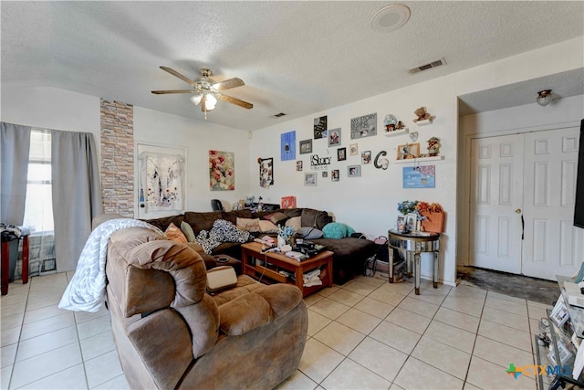 living room featuring a textured ceiling, ceiling fan, and light tile patterned flooring