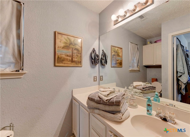 bathroom featuring vanity and a textured ceiling