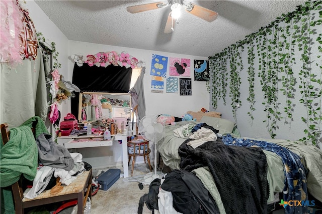 bedroom with a textured ceiling and ceiling fan