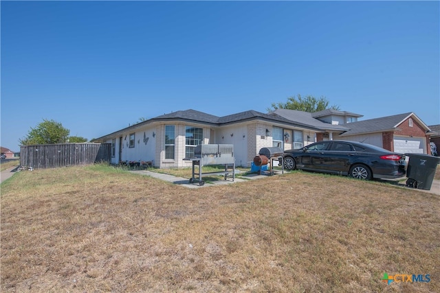 ranch-style house with a front lawn