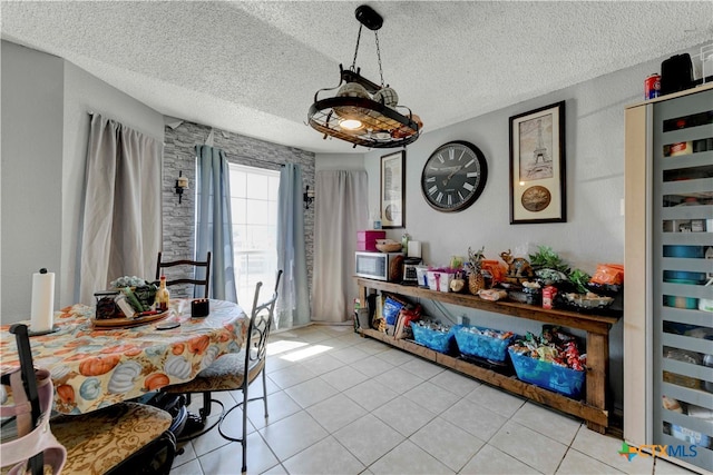 dining space featuring beverage cooler, a textured ceiling, and light tile patterned floors