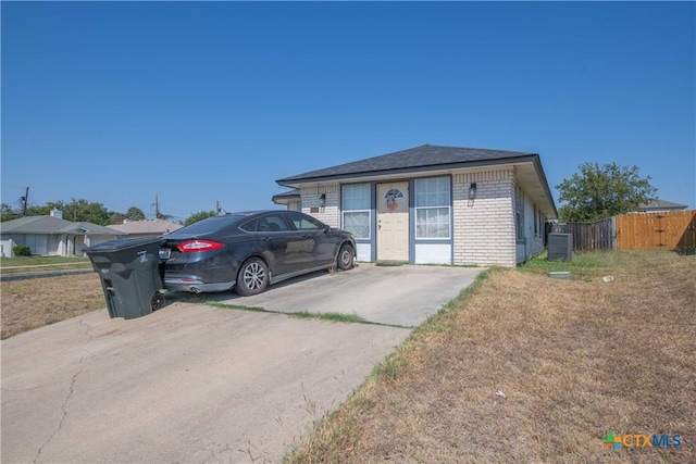 2201 Tracey Ann Ln, Killeen, TX 76543 - view of front of home featuring brick siding, central AC unit, and a shingled roof