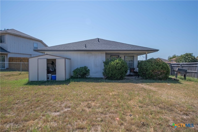 rear view of property featuring a yard