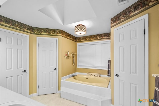 full bathroom featuring a bath, tile patterned flooring, visible vents, and baseboards