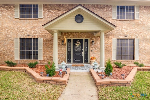 property entrance with brick siding