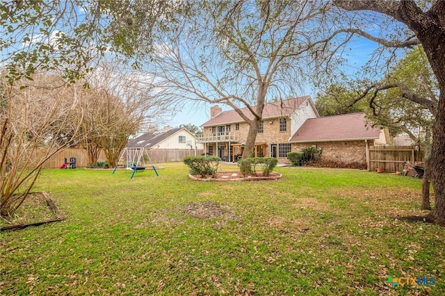 view of yard with a fenced backyard and a playground