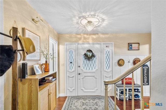 foyer with stairs and wood finished floors