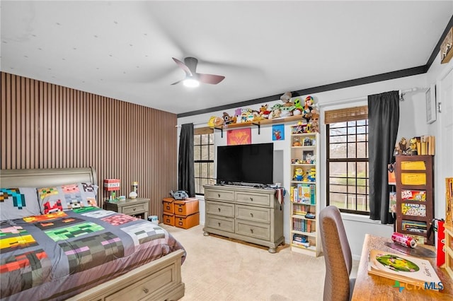 bedroom featuring light carpet and a ceiling fan