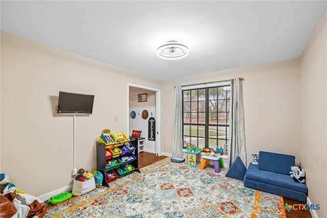 rec room with dark wood-style floors and baseboards