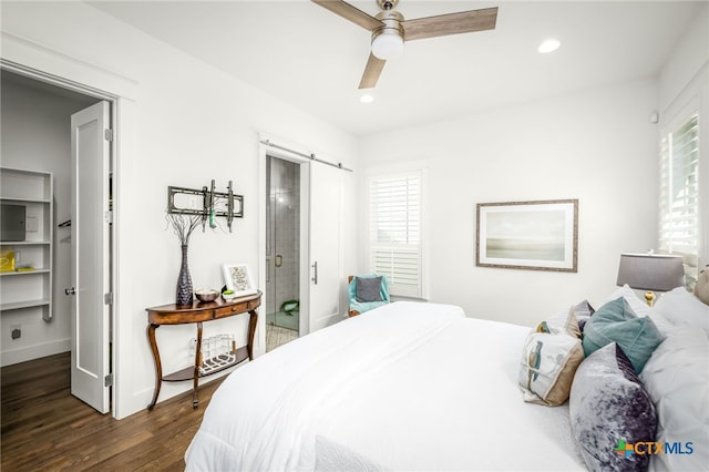bedroom featuring dark wood finished floors, a barn door, recessed lighting, and a ceiling fan