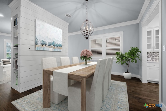 dining room with crown molding and dark wood-type flooring