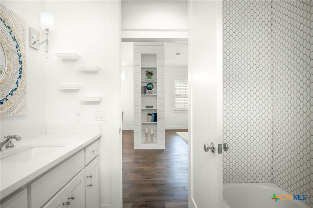 full bath featuring vanity and wood finished floors
