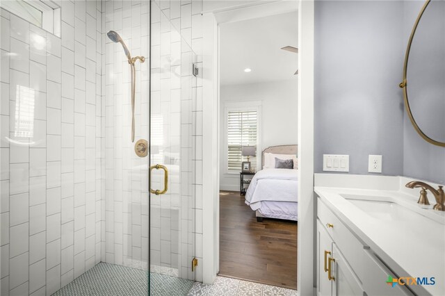 ensuite bathroom with vanity, a shower stall, and connected bathroom