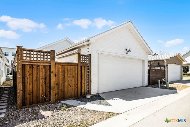 view of side of property with an outbuilding and fence
