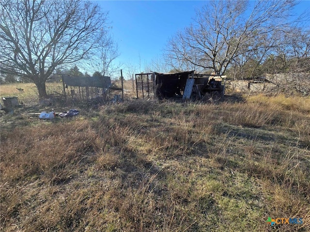 view of yard with an outbuilding and a rural view