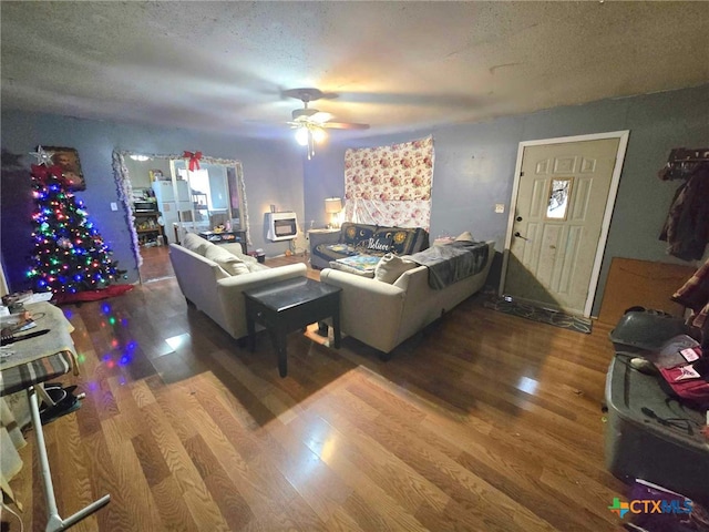 living room featuring ceiling fan, a textured ceiling, and hardwood / wood-style flooring