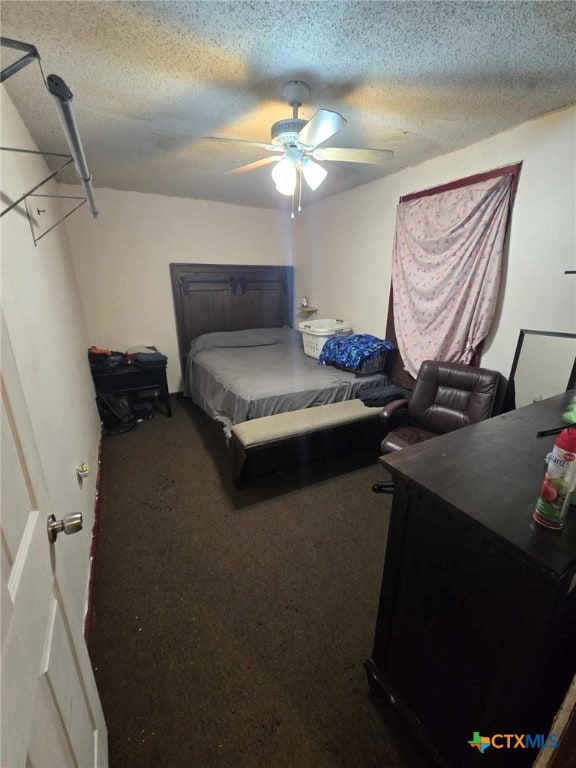 bedroom with carpet flooring, ceiling fan, and a textured ceiling