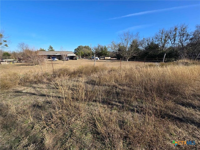 view of yard with a rural view