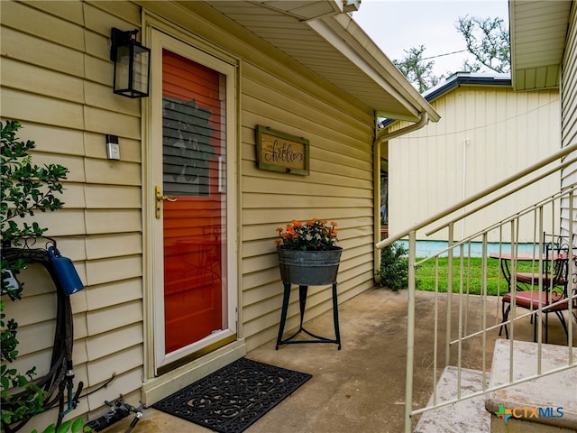 doorway to property with a patio area