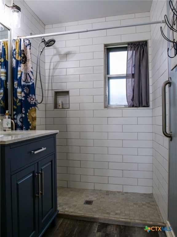 bathroom featuring a shower with shower curtain, wood-type flooring, and vanity