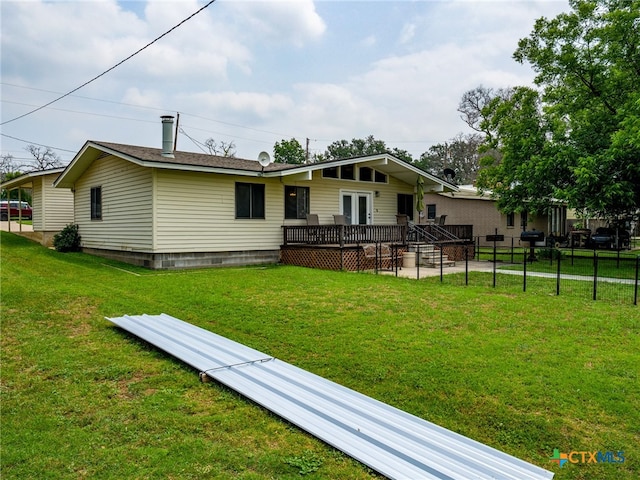 back of property featuring a yard and a wooden deck