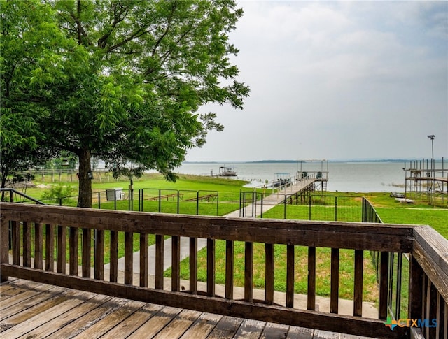 deck with a yard and a water view