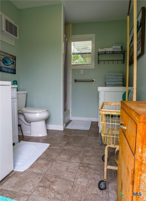 bathroom with a shower with curtain, tile patterned floors, vanity, and toilet