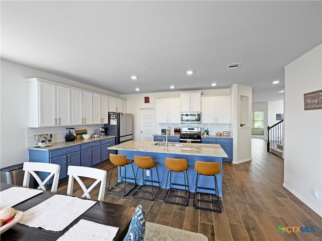 327 Steele Way, Cibolo, TX 78108 - kitchen with appliances with stainless steel finishes, tasteful backsplash, white cabinetry, a sink, and recessed lighting