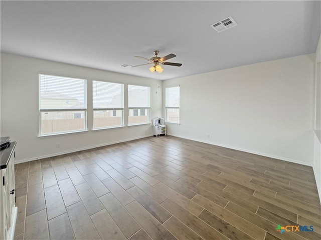 327 Steele Way, Cibolo, TX 78108 - unfurnished room with a ceiling fan, wood finished floors, and baseboards