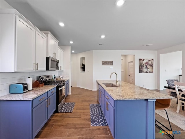327 Steele Way, Cibolo, TX 78108 - kitchen with appliances with stainless steel finishes, blue cabinetry, a sink, backsplash, and recessed lighting