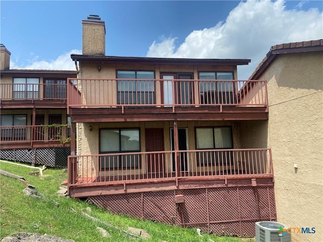 116 Campbell Dr Unit 9, Canyon Lake, TX 78133 - back of property with a chimney, stucco siding, and central air condition unit