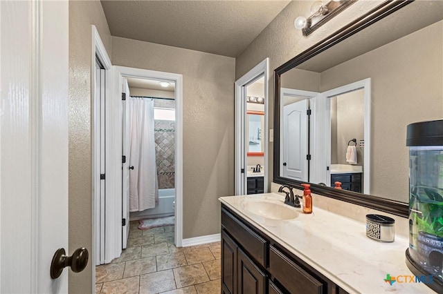 965 Ridgeoak Dr, Belton, TX 76513 - bathroom featuring vanity, a textured wall, shower / bath combo with shower curtain, and a textured ceiling