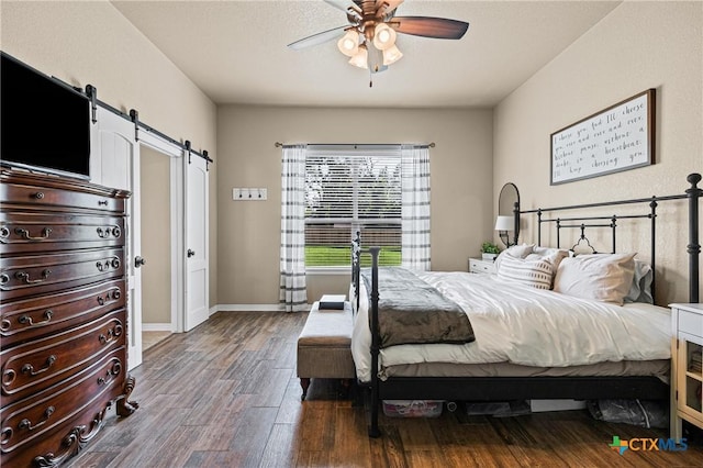 965 Ridgeoak Dr, Belton, TX 76513 - bedroom featuring a barn door, dark wood-style floors, and ceiling fan
