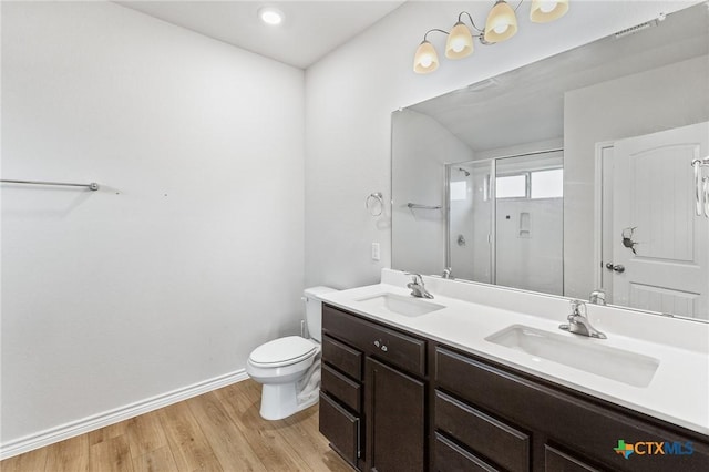 5836 Copano Rd, Belton, TX 76513 - full bathroom featuring a shower with door, double vanity, and wood finished floors